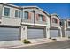 Townhome exterior with multi-car garage, modern design, and well-kept landscaping at 7348 N Decatur Blvd # 5, Las Vegas, NV 89131