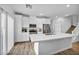 Modern kitchen with white cabinetry, stainless steel appliances, and an expansive quartz island at 7348 N Decatur Blvd # 5, Las Vegas, NV 89131