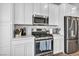 Bright kitchen features white cabinets, stainless steel appliances, and light countertops at 7348 N Decatur Blvd # 5, Las Vegas, NV 89131