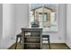 Office space with small table, shelving and stools near a window with a view of other homes at 7348 N Decatur Blvd # 5, Las Vegas, NV 89131