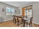 Bright dining room featuring hardwood floors, a dark wood table, and modern chairs at 741 Monroe Hill Pl, Henderson, NV 89011