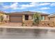 Charming single-story home with a well-manicured front yard and a two-car garage at 741 Monroe Hill Pl, Henderson, NV 89011
