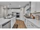 Modern kitchen with white cabinets, stainless steel appliances, and wood-look flooring at 741 Monroe Hill Pl, Henderson, NV 89011