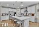 Bright open kitchen with a large island, stainless steel appliances, and modern pendant lighting at 741 Monroe Hill Pl, Henderson, NV 89011