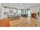 Open concept kitchen and dining area featuring a large island with seating and modern lighting at 741 Monroe Hill Pl, Henderson, NV 89011