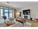 Bright living room with a slider leading outside and a stylish entertainment center and seating at 741 Monroe Hill Pl, Henderson, NV 89011