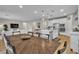 Open-concept living area with a modern kitchen and a connected dining and living room at 741 Monroe Hill Pl, Henderson, NV 89011