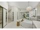 Spacious bathroom featuring a freestanding tub, double vanities, and a large, mirrored wardrobe at 9 Cozy Glen Cir, Henderson, NV 89074