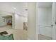 Bright hallway with neutral colors, carpet flooring, and an open view of the nearby kitchen at 9 Cozy Glen Cir, Henderson, NV 89074