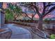 Landscaped backyard with stone walkway, mature trees and manicured shrubs at 9425 San Laguna Ct # 102, Las Vegas, NV 89134