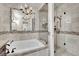 Elegant bathroom featuring a soaking tub, walk-in shower, and decorative tile accents at 9425 San Laguna Ct # 102, Las Vegas, NV 89134