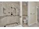 Modern bathroom with glass-enclosed shower and tiled walls, featuring a sleek toilet at 9425 San Laguna Ct # 102, Las Vegas, NV 89134