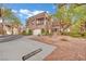 Two-story house with a garage, balcony, and desert landscaping at 9425 San Laguna Ct # 102, Las Vegas, NV 89134