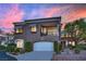 Charming two-story home with manicured landscaping and inviting curb appeal at sunset at 9425 San Laguna Ct # 102, Las Vegas, NV 89134
