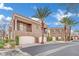 A two-story building with a two-car garage and beautiful landscaping at 9425 San Laguna Ct # 102, Las Vegas, NV 89134