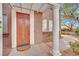 Elegant wood front door with a decorative design and covered porch at 9425 San Laguna Ct # 102, Las Vegas, NV 89134