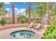 Outdoor hot tub area with lounge chairs and mature landscaping at 9425 San Laguna Ct # 102, Las Vegas, NV 89134