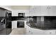 Spacious kitchen featuring white cabinets, black countertops, and stainless steel appliances at 9425 San Laguna Ct # 102, Las Vegas, NV 89134