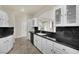 Kitchen with white cabinets, black countertops and stainless steel appliances at 9425 San Laguna Ct # 102, Las Vegas, NV 89134