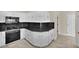 Corner view of the kitchen with white cabinets, black countertops and stainless steel appliances at 9425 San Laguna Ct # 102, Las Vegas, NV 89134