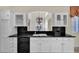 Well-appointed kitchen with white cabinets and black countertops at 9425 San Laguna Ct # 102, Las Vegas, NV 89134