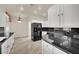 Modern kitchen with white cabinets, black granite countertops, and stainless steel appliances at 9425 San Laguna Ct # 102, Las Vegas, NV 89134