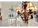 Living room with tile floor, a view through french doors, and decorative chandelier at 9425 San Laguna Ct # 102, Las Vegas, NV 89134