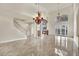 Expansive living area featuring dual chandeliers, sleek flooring, and an elegant fireplace at 9425 San Laguna Ct # 102, Las Vegas, NV 89134