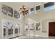 Bright living room with high ceilings, large windows, and a view to the backyard at 9425 San Laguna Ct # 102, Las Vegas, NV 89134