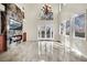Living room with fireplace and TV over it, a view through french doors, and decorative chandelier at 9425 San Laguna Ct # 102, Las Vegas, NV 89134