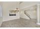 Spacious living room featuring tile floors, high ceilings, and an elegant chandelier at 9425 San Laguna Ct # 102, Las Vegas, NV 89134