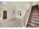 Elegant living room with stairs, featuring tile floors, high ceilings, and a chandelier at 9425 San Laguna Ct # 102, Las Vegas, NV 89134