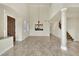 Open living area with tiled floors, chandelier lighting, and open access to the kitchen area at 9425 San Laguna Ct # 102, Las Vegas, NV 89134