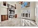 Bright living room features a stone fireplace, media center, and French doors to outside at 9425 San Laguna Ct # 102, Las Vegas, NV 89134
