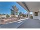 Covered back patio with meticulous low-maintenance landscaping and a rock garden at 9704 Brawley Dr, Las Vegas, NV 89134