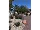 Charming backyard with rose bushes, lavender, rock features, and a vine-covered archway at 9704 Brawley Dr, Las Vegas, NV 89134