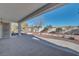 Covered patio offering shade and a pleasant view of the landscaped backyard at 9704 Brawley Dr, Las Vegas, NV 89134