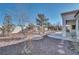 Wide shot of the backyard featuring low-maintenance landscaping, mature trees, and partial view of the patio at 9704 Brawley Dr, Las Vegas, NV 89134