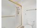 Clean bathroom with white walls, a sleek glass-enclosed shower with gold trim, and a matching gold towel rack at 9704 Brawley Dr, Las Vegas, NV 89134