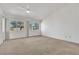 Bright bedroom featuring a vaulted ceiling, carpet, and multiple windows, offering abundant natural light at 9704 Brawley Dr, Las Vegas, NV 89134