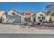 Charming single-story home featuring a well-manicured front yard and a two-car garage at 9704 Brawley Dr, Las Vegas, NV 89134