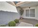 A covered front porch area with space for seating and decorative plants at 9704 Brawley Dr, Las Vegas, NV 89134