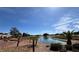 Scenic view of a well-maintained golf course with a beautiful pond and palm trees under a blue sky at 9704 Brawley Dr, Las Vegas, NV 89134