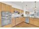 Bright kitchen featuring wood cabinets, stainless steel appliances, and granite countertops at 9704 Brawley Dr, Las Vegas, NV 89134