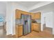 Bright kitchen features wood cabinets, granite counters and stainless steel refrigerator at 9704 Brawley Dr, Las Vegas, NV 89134