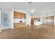 Open-concept living room with hardwood floors and built-in cabinets flows into the kitchen area at 9704 Brawley Dr, Las Vegas, NV 89134