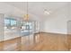 Open living area with hardwood floors, sliding glass doors, and windows providing ample natural light at 9704 Brawley Dr, Las Vegas, NV 89134
