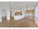 Open-concept living room and kitchen with hardwood floors, light-colored cabinetry, and modern fixtures at 9704 Brawley Dr, Las Vegas, NV 89134