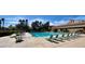 Community pool area with lounge chairs and well-maintained landscaping, perfect for relaxation at 9704 Brawley Dr, Las Vegas, NV 89134