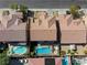 Stunning aerial perspective showcasing tile roofs, landscaping, and private pools in a tranquil setting at 9950 Waxberry Ct, Las Vegas, NV 89178